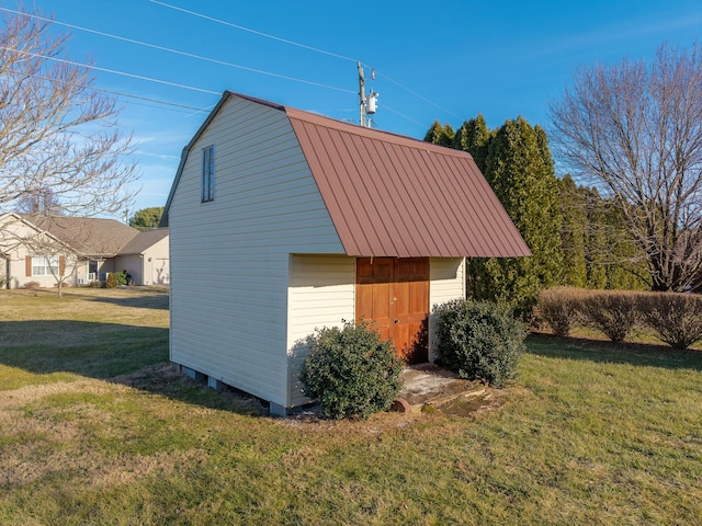 view of property exterior featuring an outbuilding and a lawn