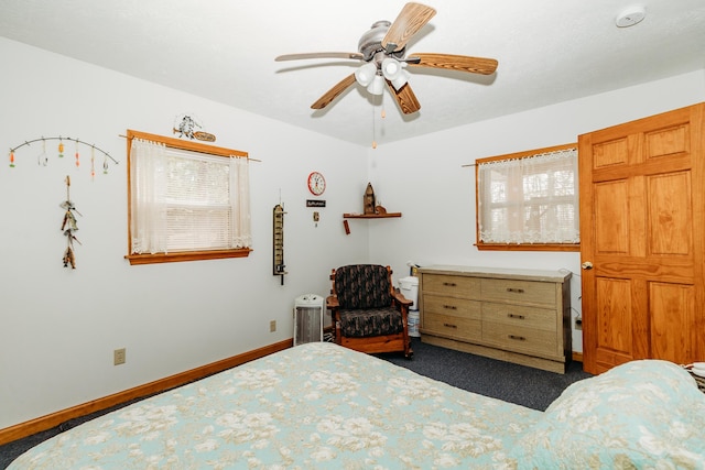 bedroom featuring dark colored carpet and ceiling fan