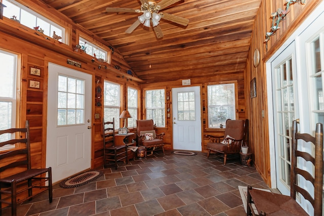 sunroom / solarium featuring vaulted ceiling, wooden ceiling, and ceiling fan