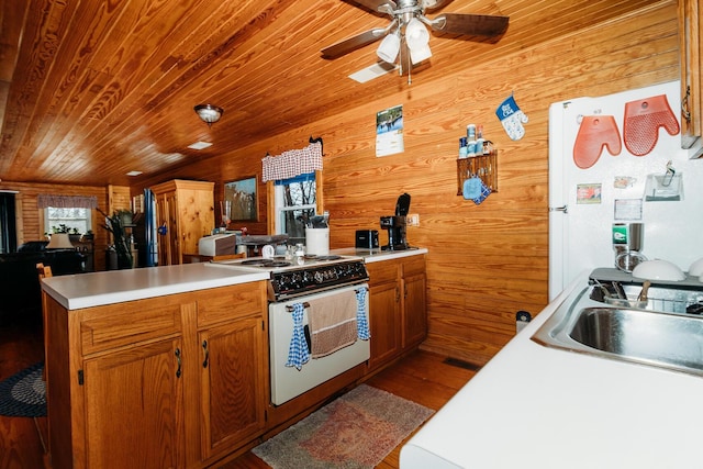 kitchen with sink, wood ceiling, wooden walls, white appliances, and light hardwood / wood-style floors