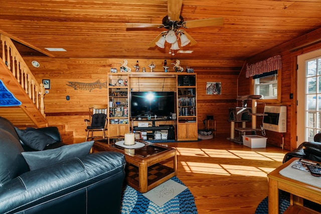 living room with heating unit, wood walls, wood ceiling, hardwood / wood-style flooring, and ceiling fan