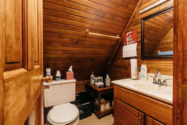 bathroom with lofted ceiling, wood ceiling, vanity, toilet, and wood walls