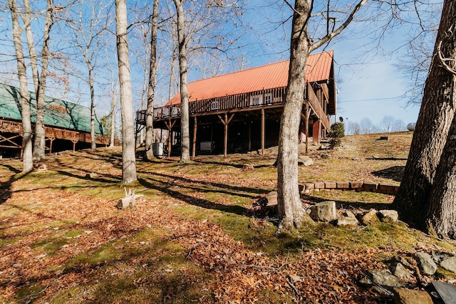 view of yard featuring a wooden deck and central AC unit