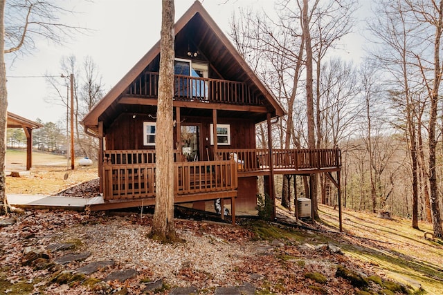 rear view of property featuring a deck