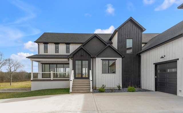 modern inspired farmhouse with a garage and a porch