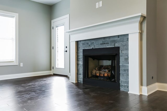 room details with a stone fireplace and hardwood / wood-style floors