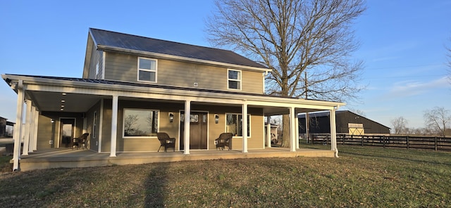 back of house with a yard and a patio