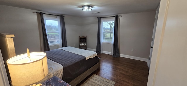 bedroom with dark hardwood / wood-style flooring