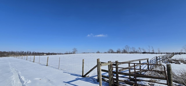 yard layered in snow featuring a rural view