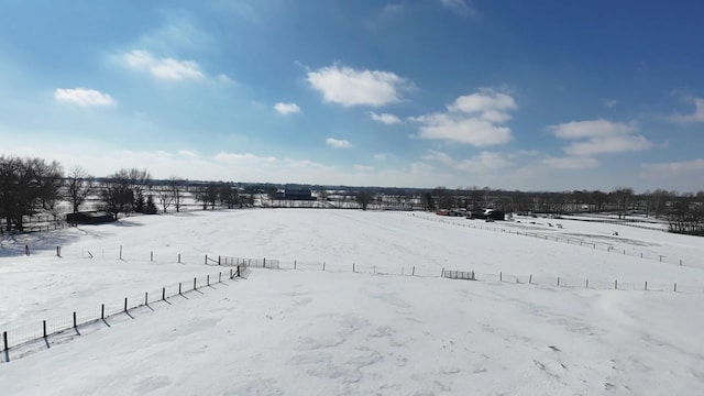 snowy aerial view featuring a rural view