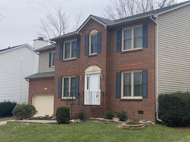 view of front facade with a garage and a front yard