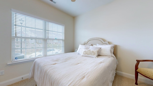 bedroom with light colored carpet