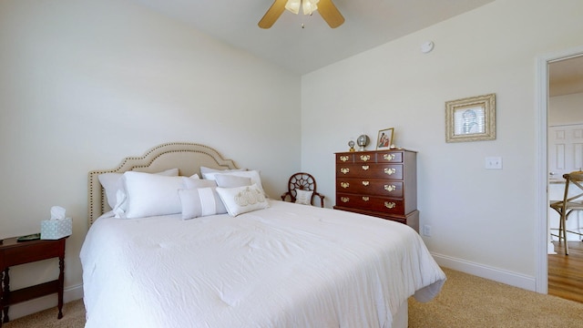 bedroom featuring ceiling fan, light colored carpet, and lofted ceiling