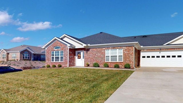 single story home featuring a garage and a front lawn