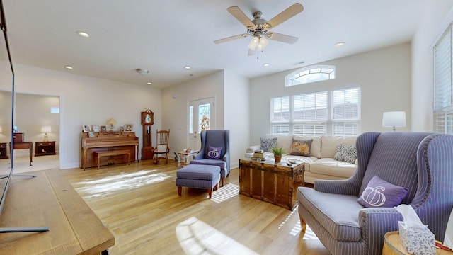 living room with ceiling fan and light wood-type flooring