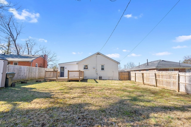 back of property featuring a lawn and a deck