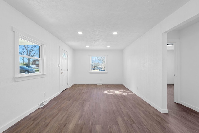 interior space with dark hardwood / wood-style floors and a textured ceiling