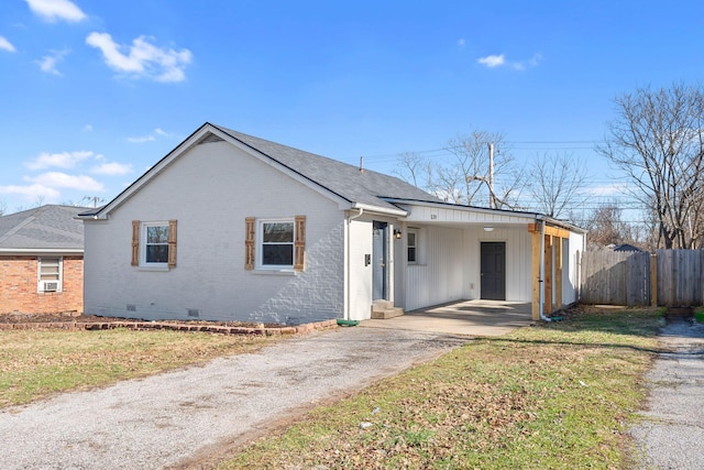 view of front of property with a carport and a front lawn