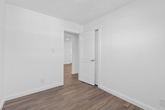 empty room with hardwood / wood-style floors