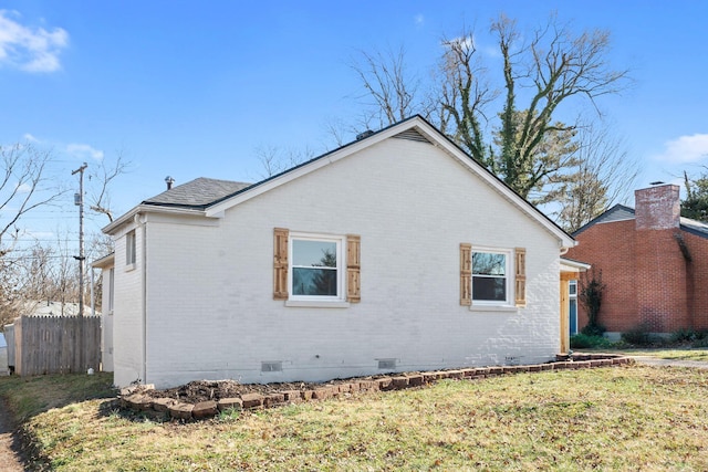 view of side of property with a yard