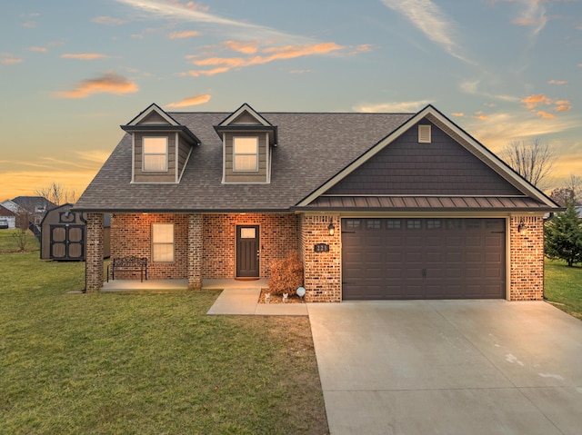 view of front of home with brick siding, roof with shingles, concrete driveway, a garage, and a front lawn