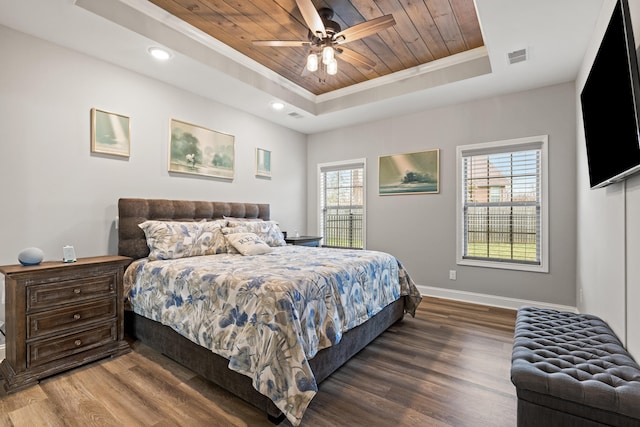 bedroom featuring wooden ceiling, baseboards, a tray ceiling, and wood finished floors