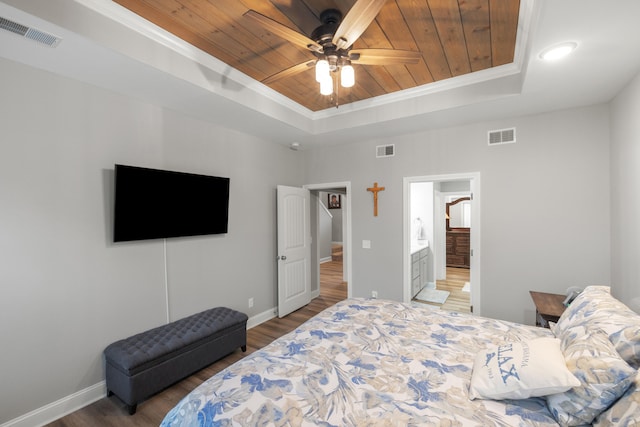 bedroom with a tray ceiling, wooden ceiling, and visible vents