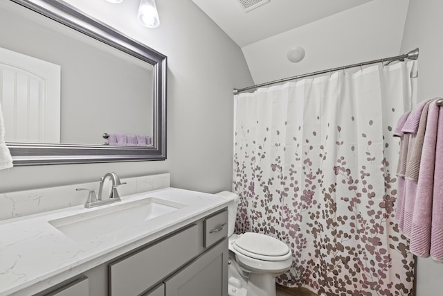 bathroom with a shower with shower curtain, visible vents, vanity, and toilet