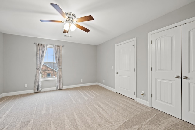 unfurnished bedroom featuring a ceiling fan, carpet, visible vents, and baseboards