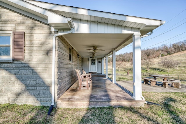 view of patio with ceiling fan and a porch