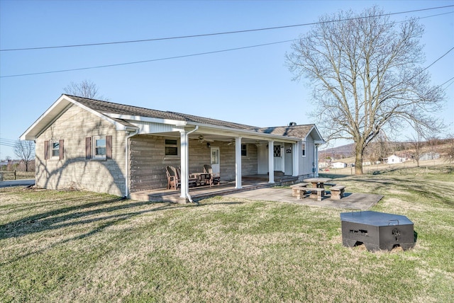 view of front facade with a patio and a front yard