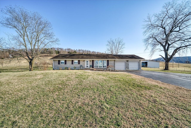 ranch-style home with a garage and a front lawn