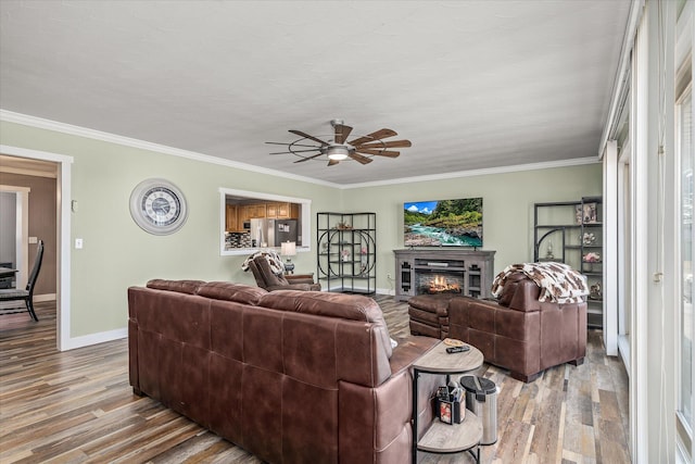 living room featuring crown molding and light hardwood / wood-style flooring