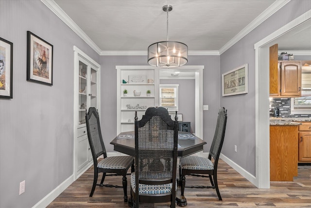dining space with an inviting chandelier, dark wood-type flooring, and ornamental molding