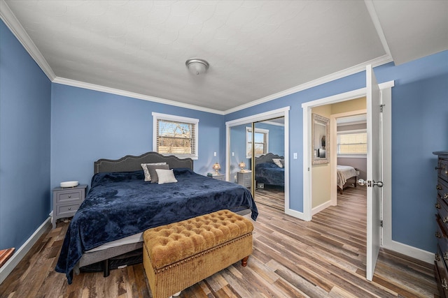 bedroom featuring hardwood / wood-style flooring, ornamental molding, and a closet