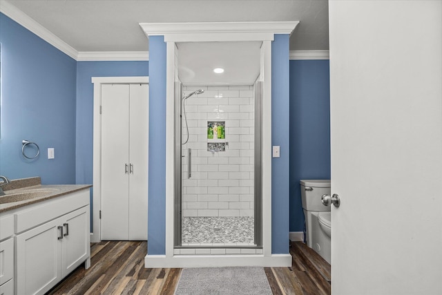 bathroom featuring vanity, hardwood / wood-style floors, ornamental molding, and walk in shower