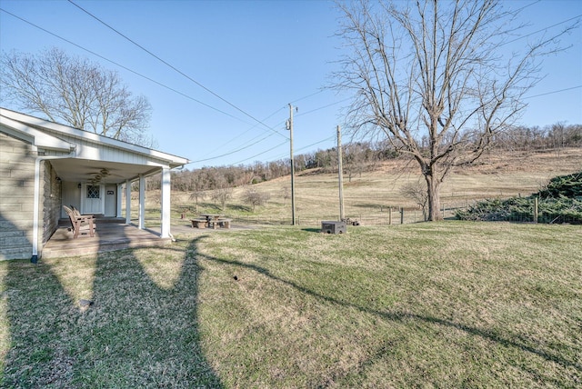 view of yard with a rural view and a patio area
