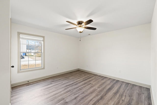 empty room with ceiling fan and wood-type flooring