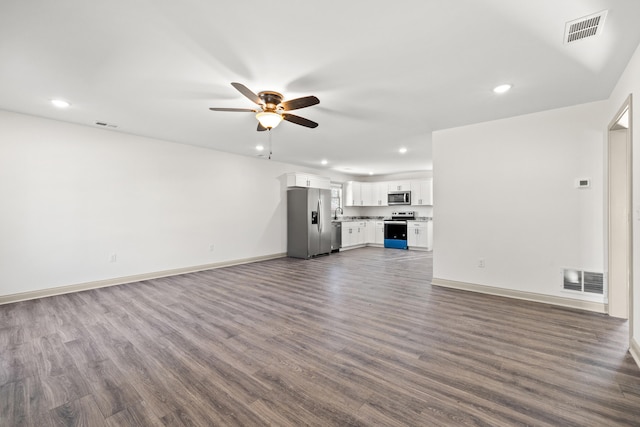 unfurnished living room featuring ceiling fan and dark hardwood / wood-style flooring