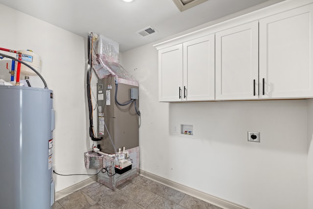 washroom featuring cabinets, hookup for a washing machine, electric water heater, and hookup for an electric dryer