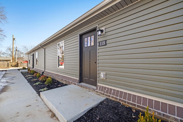 view of exterior entry featuring a patio area