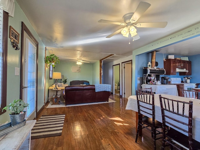 living room with dark hardwood / wood-style flooring and ceiling fan