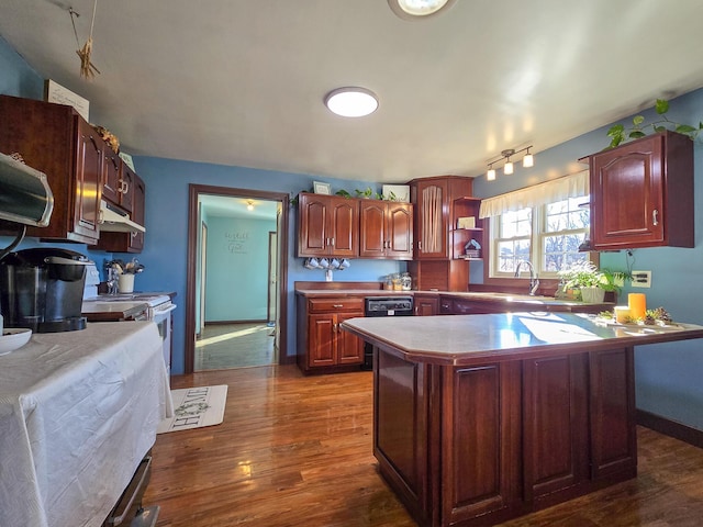 kitchen with a kitchen island, dark hardwood / wood-style floors, sink, and white range oven