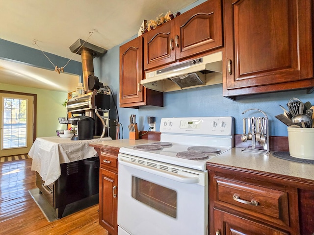 kitchen featuring light hardwood / wood-style floors and white range with electric cooktop