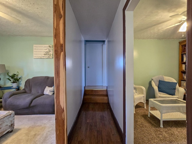 corridor with wood-type flooring and a textured ceiling