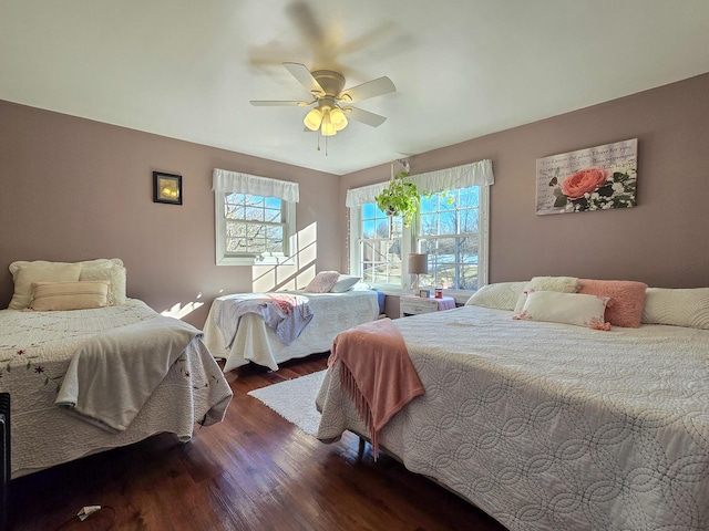 bedroom featuring ceiling fan and dark hardwood / wood-style floors