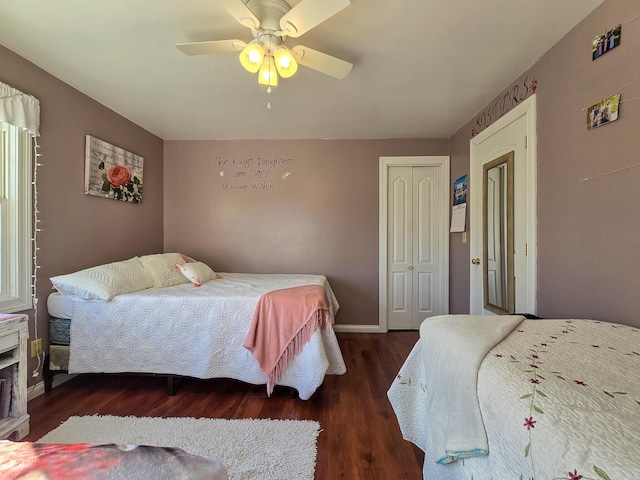 bedroom with ceiling fan, dark hardwood / wood-style flooring, and a closet