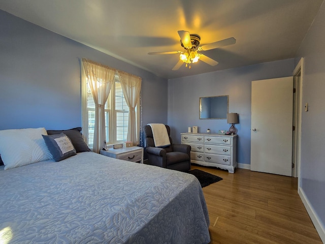 bedroom with wood-type flooring and ceiling fan