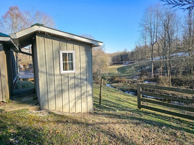 view of outbuilding with a yard and a water view