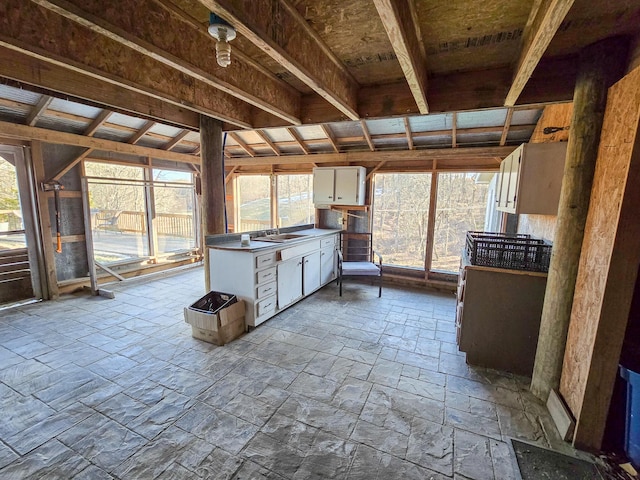 unfurnished sunroom featuring plenty of natural light and sink